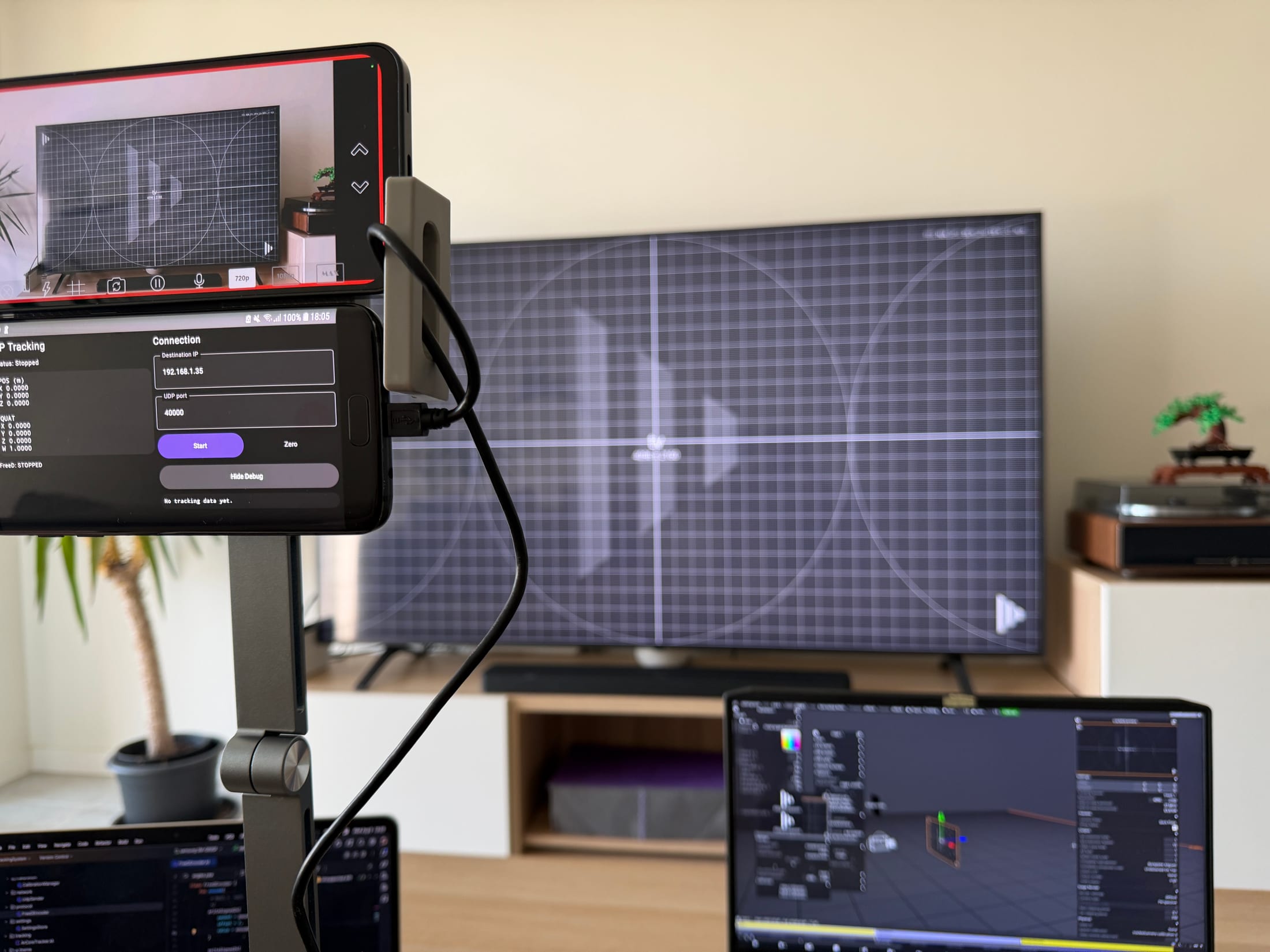 Phone tracking rig in front of a virtual production test scene